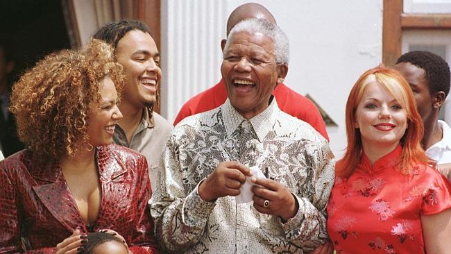  FILE -- South Africa's President Nelson Mandela, is flanked by Spice Girls Melanie Brown Geri Halliwell in South Africa in 1...