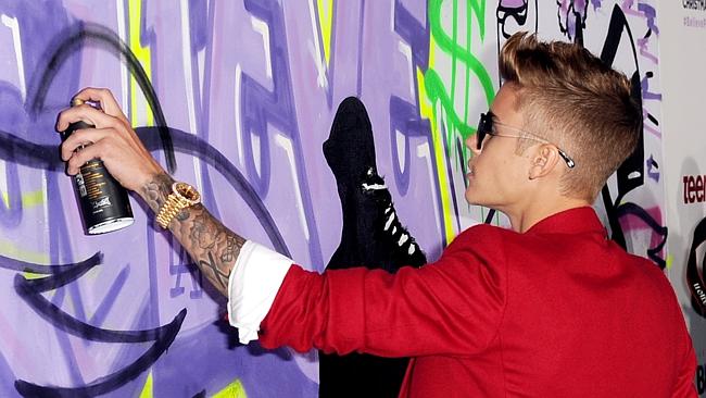Singer Justin Bieber indulges in spray painting at the LA premiere of his documentary Believe on December 18.