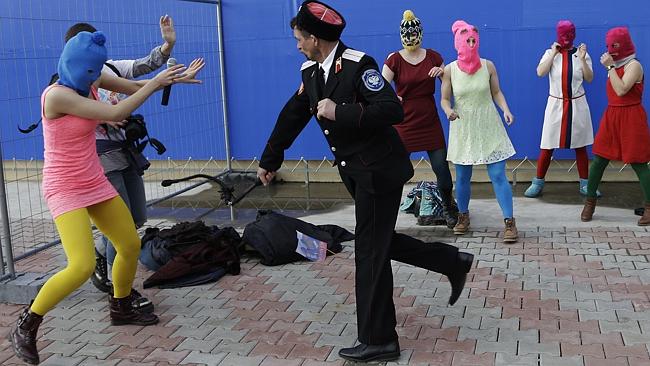 aPublic whipping ... a Cossack militiaman attacks Pussy Riot member Nadezhda Tolokonnikov