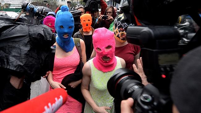 Wearing masks members of Russian punk group Pussy Riot, Nadezhda Tolokonnikova (L) and Ma