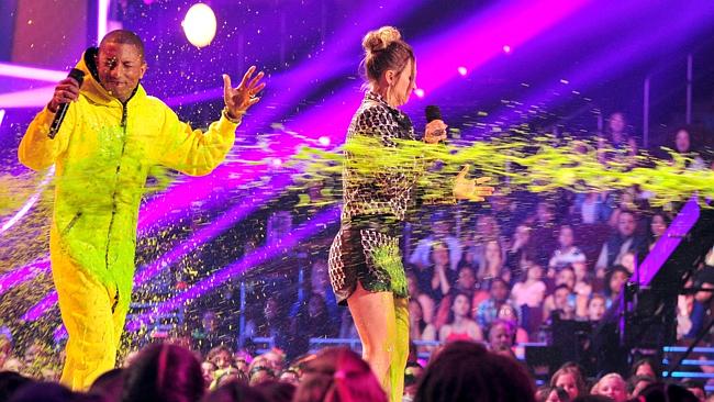 Messy business ... Pharrell Williams and actress Kaley Cuoco-Sweeting get slimed during t