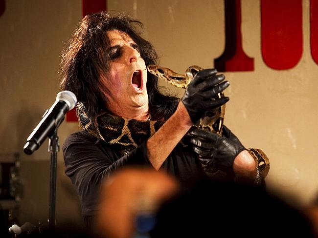Singer Alice Cooper with a snake performs on stage with his rock band at The 100 Club on Oxford Street in London, 26/06/2011...