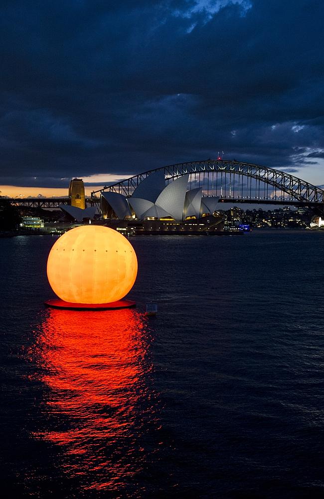 Sun orb in Sydney Harbour for dress rehearsals for Madama Butterfly, which opens on March