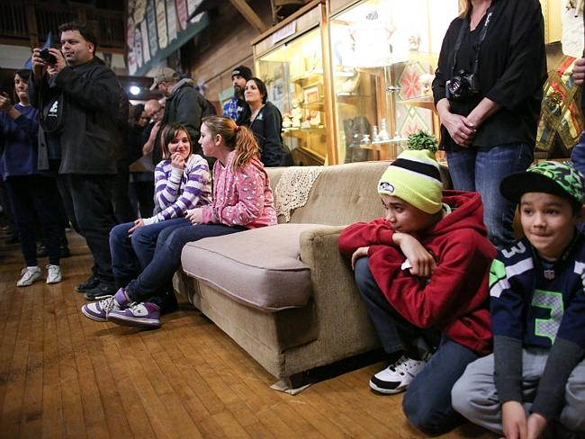 People sit on a couch said to be once owned by Kurt Cobain during the first annual Kurt C