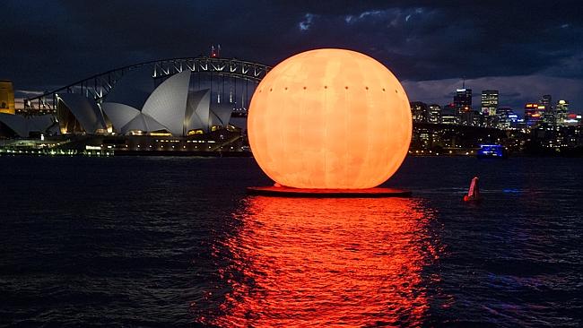 Sun orb in Sydney Harbour for dress rehearsals for Madama Butterfly, which opens on March
