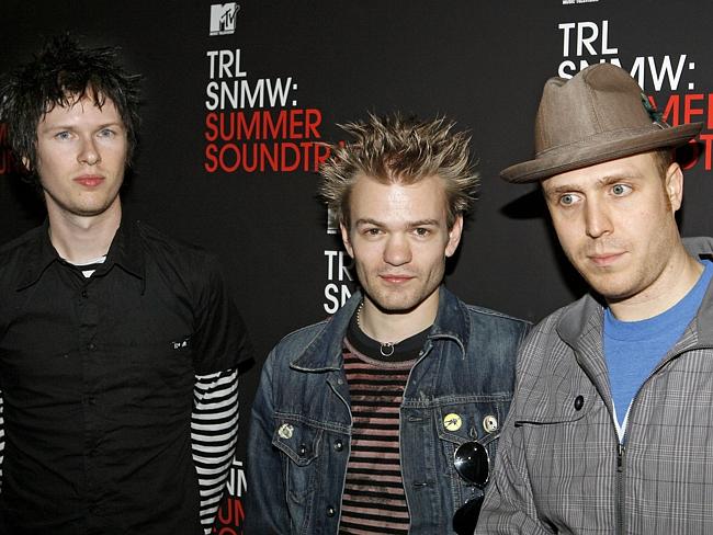Members of Sum 41 Cone McCaslin, Deryck Whibley (middle) and Steve Jocz.