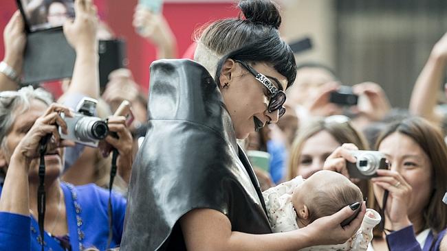 Really little monster ... Lady Gaga greets a young fan after she arrives at Crown Perth, 