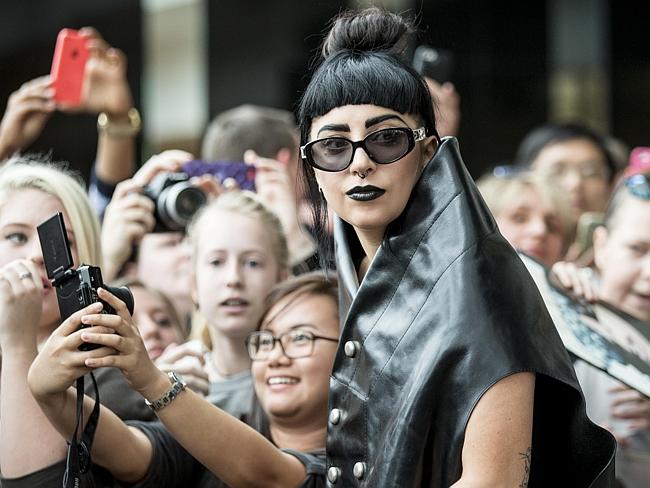 Leather clad ... Lady Gaga surrounded by adoring fans.