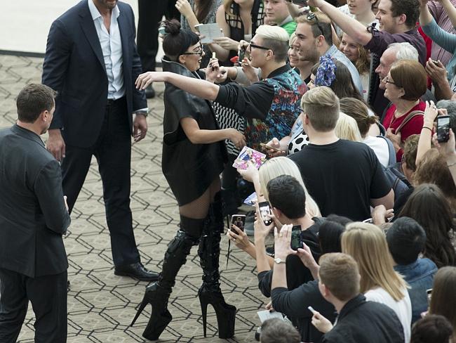 Hugs ... Lady Gaga looked typically eye-catching in extravagant boots.