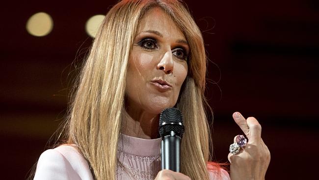 Tour cancelled ... Celine Dion crosses her fingers as she speaks about her husband Rene A
