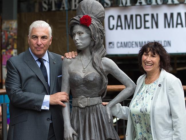 Family support ... Mitch Winehouse and Janis Winehouse pose for a picture with a statue o