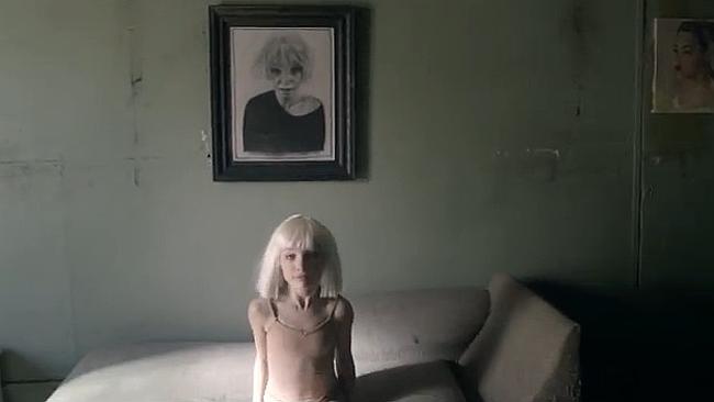 Maddie Ziegler dances under the portrait of Sia that helped her get sober.