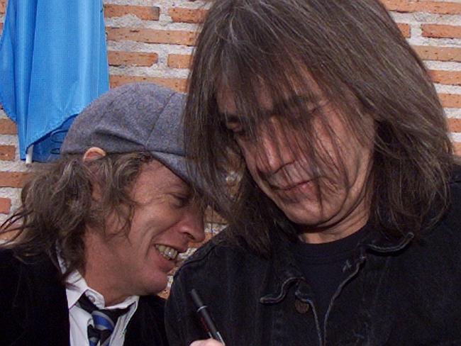 Angus Young (left) and brother Malcolm Young (R) of the hard rock group AC/DC in 2000.