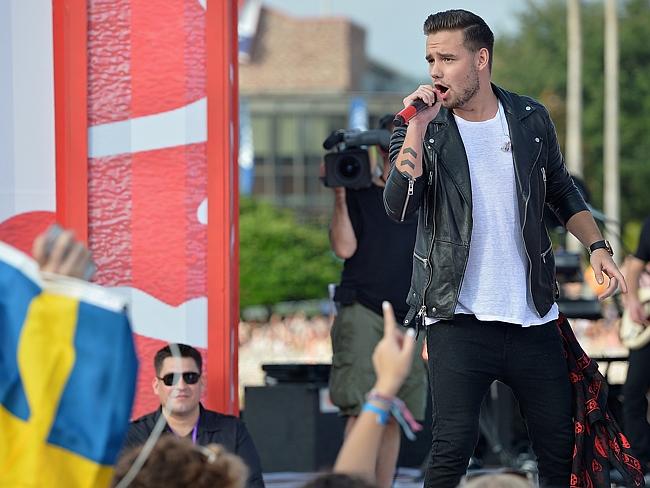 Show goes on...Liam Payne performs in Florida, where the band launched their new album wi