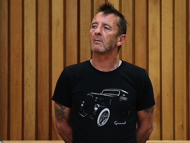 Crisis ... AC/DC drummer Phil Rudd appears in court after being charged with threatening 