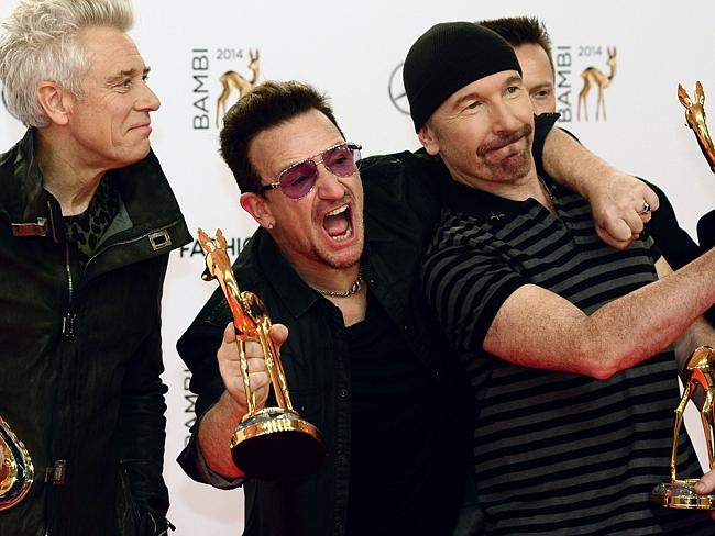 Tour ... Irish singer-songwriter Bono (2nd L) and members of his band U2 pose with their 