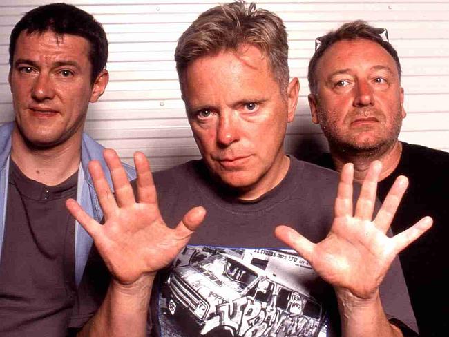 New Order down to a trio in 2002 — Peter Hook’s face says it all.