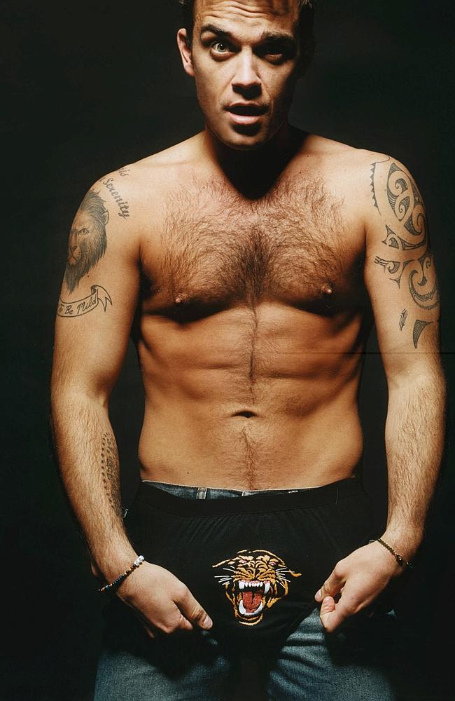 Seen me abs? Robbie Williams will always show off when fit. Picture: Supplied.