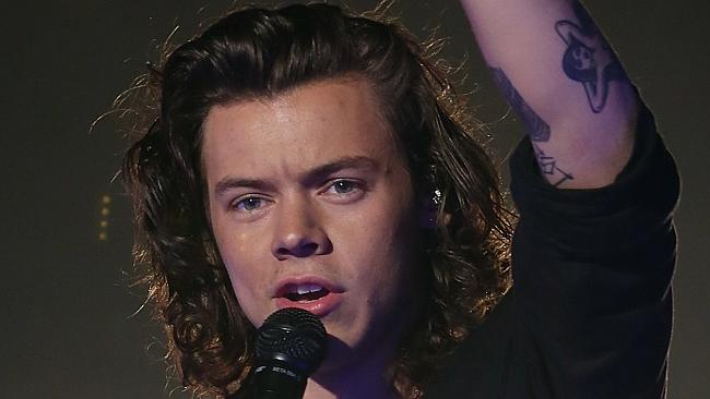 Energetic ... One Direction's Harry Styles sings to a packed Stadium in Sydney, kicking o