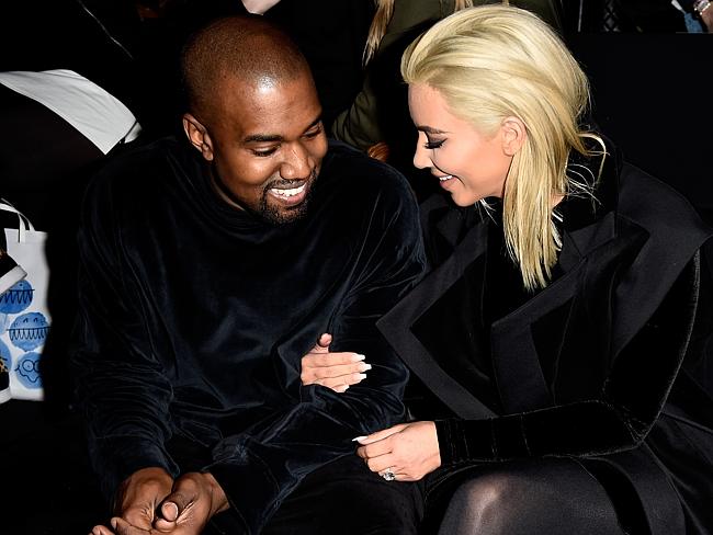 A loved-up Kanye and Kim sitting front row at Paris Fashion Week.