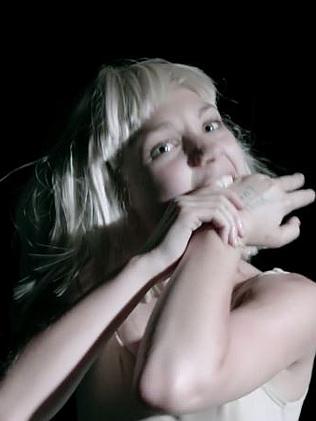 Maddie bites herself in the clip.