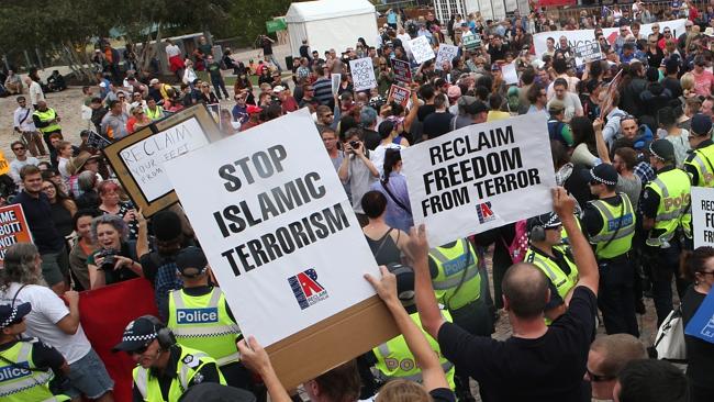Police try to keep protesters apart after a rally at Federation Square where anti-racist 