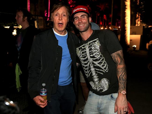 The Beatle goes on ... Paul McCartney and Adam Levine attend day one of the festival. Pic