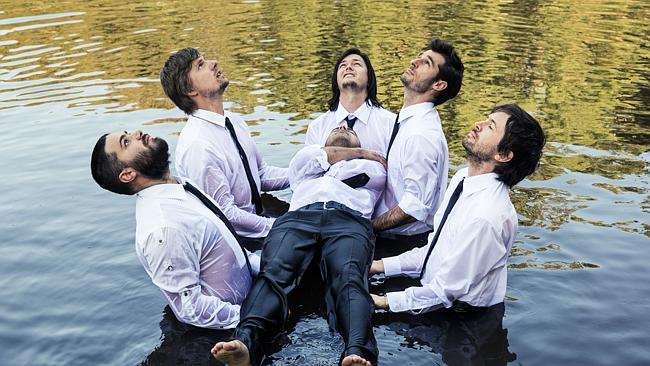 Wet cats: The Cat Empire fully commit to band photo sessions and live concerts.