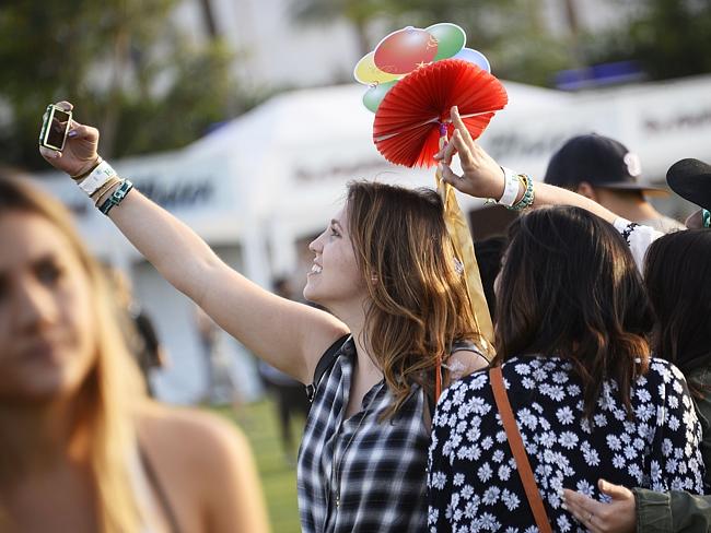 Strike the pose ... a festival-goer takes a selfie without the aid of a “selfie stick” — 