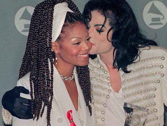 Close ... Michael Jackson kisses his sister Janet Jackson (L) after she presented him wit