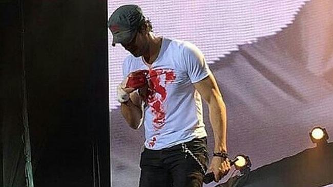 Enrique Iglesias painted a love heart on his shirt using his blood.