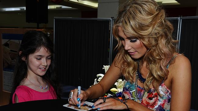 Sign of the times ... Delta Goodrem signs a CD for Sharnay Stavrow of Mt Louisa.