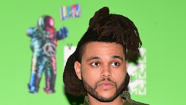 Recording artist The Weeknd poses for a photo in the press room at the MTV Video Music Aw